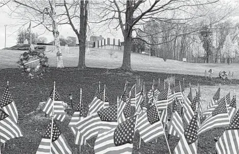  ?? RODRIQUE NGOWI/AP ?? Flags honor veterans in April at the Soldiers’ Home in Holyoke, Massachuse­tts. At least 76 there have died of COVID-19.