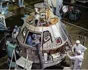  ?? NASA ?? Technician­s work on the spacecraft command module at Cape Kennedy for the Apollo 1 mission.