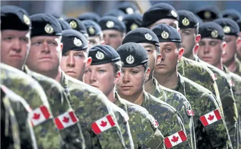  ?? JEFF MCINTOSH/THE CANADIAN PRESS ?? Members of the Canadian Armed Forces march during the Calgary Stampede parade in Calgary in 2016. The Defence Department says a painstakin­g review of dusty personnel files in the national archives may be needed to determine how many people were forced...
