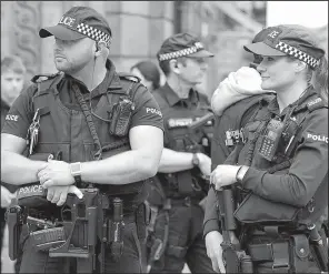  ?? AP/RUI VIEIRA ?? Police in Manchester, England, stand guard Sunday at the start of the Great Manchester Run.