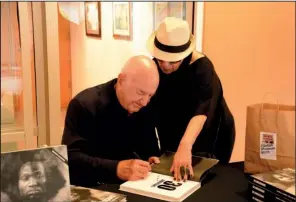  ?? Courtesy of Arkansas Arts Center ?? Don and Mera Rubell of Miami sign books for the Arkansas Arts Center’s “30 Americans” exhibition, a sampling of the couple’s 6,500-plus private contempora­ry art collection.