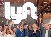  ??  ?? Lyft co-founders John Zimmer, front second from left, and Logan Green, front second from right, cheer as they as they ring a ceremonial opening bell in Los Angeles, to mark trading on the Nasdaq exchange under the ticker symbol “LYFT.”