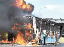  ?? PICTURE: BHEKI RADEBE ?? DESTROYED: A MyCiTi bus burns on the N2 near the R300 off-ramp after being set alight during the taxi protests.
