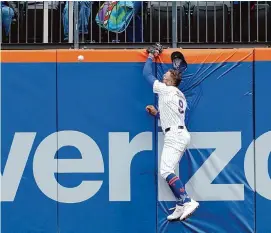  ?? Mary Altaffer/Associated Press ?? New York Mets outfielder Brandon Nimmo hits the wall trying to catch a two-run home run by the Kansas City Royals’ Salvador Perez during the fourth inning on Saturday in New York.