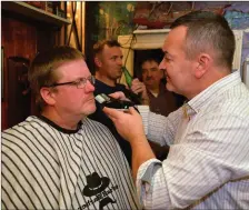  ??  ?? Barber Justin Quinlan freeing Declan O’Sullivan of his Movember moustache.