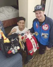  ??  ?? Ancajas with Las Vegas matchmaker Sean Gibbons displaying his boxing shorts with Toy Story character Cowboy Woody as his good luck charm