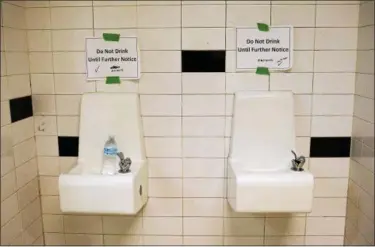  ?? ASSOCIATED PRESS FILE ?? Drinking fountains are marked “Do Not Drink Until Further Notice” at Flint Northweste­rn High School in Flint, Michigan, in 2016. Ohio school districts in the past year and a half have tested drinking fountains and faucets inside hundreds of older...