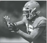  ?? JOSHUA L. JONES/ATHENS BANNER-HERALD VIA AP ?? Georgia wide receiver Lawrence Cager looks to make a catch during football practice Tuesday in Athens, Ga.