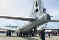  ??  ?? Donald Luger points to the tail guns of the B-29.