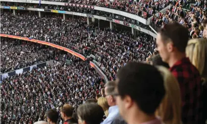  ?? Photograph: Julian Smith/AAP ?? Bombers fans pack the stands at the traditiona­l Collingwoo­d v Essendon game on Anzac Day in 2018.