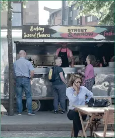  ??  ?? The Street &amp; Arrow street food project’s trailer, above, and main picture right, workers cook up a storm