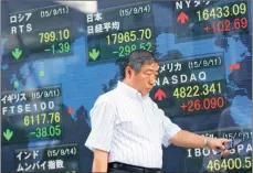  ?? PHOTO: AP ?? An electronic stock indicator of a securities firm in Tokyo. A possible hike in US interest rates this week could give Asian countries a chance to decouple from China.