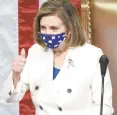  ?? DREW ANGERER/GETTY ?? Speaker of the House Nancy Pelosi gives a thumbs-up as she presides over voting on coronaviru­s relief package H.R. 1319 on Wednesday.