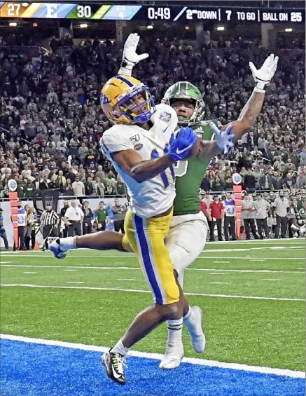  ?? Matt Freed/Post-Gazette ?? Pitt receiver Taysir Mack pulls in the go-ahead touchdown pass with less than a minute to play Thursday night in Quick Lane Bowl in Detroit. The score allowed the Panthers to pull out a 34-30 victory against Eastern Michigan. the