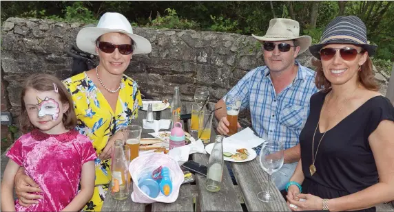  ??  ?? Grace O’Brien Monica, Leonard O’Brien and Abigail Brennan enjoying the barbecue in Aughrim in aid of the local community clean up fund.