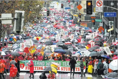  ?? Ringo H.W. Chiu The Associated Press ?? Thousands of teachers and supporters hold signs in the rain during a rally Monday in Los Angeles.