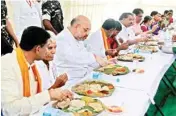  ??  ?? BJP president Amit Shah having lunch during his door-to-door campaign in a Dalit Colony at Theratpall­y village, Nalgonda, on Monday