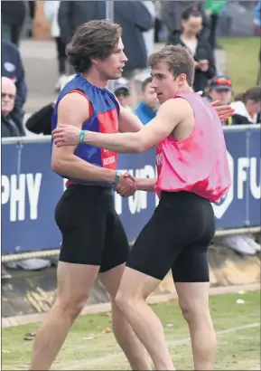  ?? Picture: PAUL CARRACHER ?? CHEERS: Goroke expat Duncan Cameron, in blue, congratula­tes Harry Kerr after Kerr won their semi-final at the 2022 Stawell Gift on Monday. Kerr went on to secure the Stawell Gift.