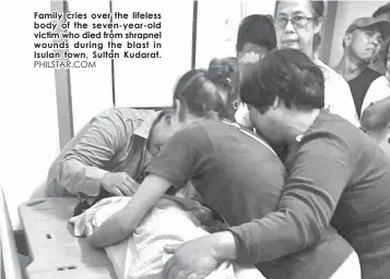  ?? PHILSTAR.COM ?? Family cries over the lifeless body of the seven-year-old victim who died from shrapnel wounds during the blast in Isulan town, Sultan Kudarat.