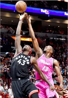  ?? — USA TODAY Sports photo ?? Toronto Raptors forward Pascal Siakam (left) tries to reach for a rebound in front of Miami Heat centre Bam Adebayo during the second half at American Airlines Arena.