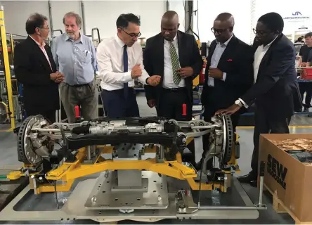  ?? Picture: SUPPLIED ?? PART OF THE PLAN: Jendamark MD Quinton Uren shows finance MEC Oscar Mabuyane, automotive industry developmen­t centre chair Weza Moss and Mabuyane's chief of staff, Bapehelele Mhlaba, the car axle being built by his factory in Port Elizabeth this week.