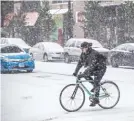  ?? | RICH HEIN/ SUN- TIMES PHOTOS ?? Whether on foot, by car or by bike, Chicagoans struggled through the snow on Friday.