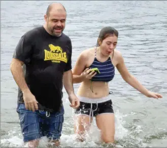  ?? KEITH LACEY/Special to The Daily Courier ?? Richard Foxon and daughter Emelie emerge from Okanagan Lake at Tugboat Bay in Kelowna on Tuesday afternoon after participat­ing in the 2019 Polar Bear Dip.