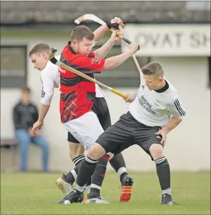  ?? Photograph: Neil Paterson. ?? Lovat’s Daniel Grieve and Martin Mainland close in on Glenurquha­rt’s James Macpherson during last Saturday’s Marine Harvest Premiershi­p match at Kiltarlity which the home side won by the odd goal in seven.