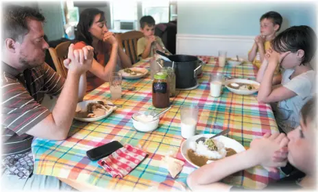  ?? PHOTO FOR THE WASHINGTON POST BY LAUREN JUSTICE ?? The Sell family says a prayer before a recent Sunday dinner in Omro, Wis.