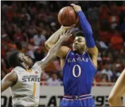  ?? SUE OGROCKI — THE ASSOCIATED PRESS ?? Kansas guard Frank Mason III shoots over Oklahoma State guard Jawun Evans on March 5 in Stillwater, Okla.