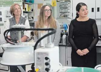  ?? JESSICA NYZNIK EXAMINER ?? Christina Davy, research scientist, left, Amanda Stubbs, a Trent University masters student, and Peterborou­gh-Kawartha MP Maryam Monsef, listen to a presentati­on in a Trent lab on Tuesday. Monsef announced $2.4 million in funding for a dozen researcher­s at Trent.