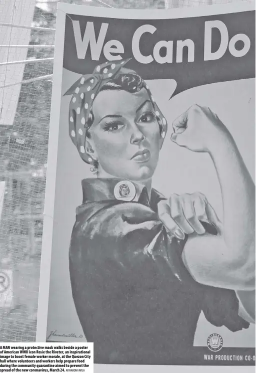  ?? AP/AARON Favila ?? A man wearing a protective mask walks beside a poster of American WWII icon Rosie the Riveter, an inspiratio­nal image to boost female worker morale, at the Quezon City hall where volunteers and workers help prepare food during the community quarantine aimed to prevent the spread of the new coronaviru­s, march 24.