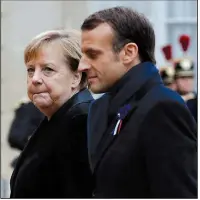  ?? AP/THIBAULT CAMUS ?? French President Emmanuel Macron (right) and German Chancellor Angela Merkel arrive for lunch at Elysee Palace in Paris after ceremonies marking the 100th anniversar­y of the end of World War I.