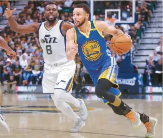  ?? AP-Yonhap ?? Golden State Warriors guard Stephen Curry, right, drives as Utah Jazz guard Shelvin Mack defends in the first half during Game 4 of the NBA basketball second-round playoff series in Salt Lake City, Monday.