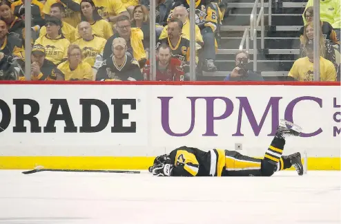  ??  ?? Not everyone was concerned to see Sidney Crosby splayed out on the ice after taking a hit to the head from the Capitals’ Matt Niskanen. GREGORY SHAMUS / GETTY IMAGES