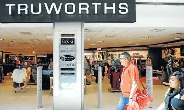  ?? Picture: GALLO IMAGES ?? BUSINESS MODEL: Shoppers walk past a Truworths store in Cape Town. CEO Michael Mark says it is not viable to transform Truworths into a cash business because, people are too poor to afford the clothing without credit