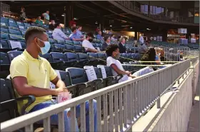  ?? (Arkansas Democrat-Gazette/Staci Vandagriff) ?? Dennis Smith (left) of Little Rock listens to Scott McLean, founder and executive director of Pathway to Freedom, during the Pathway to Freedom Fall Classic on Wednesday at Dickey-Stephens Park in North Little Rock.