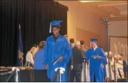  ??  ?? Saratoga Springs High School senior Khaleel Muldrow receives his completion certificat­e Monday night.