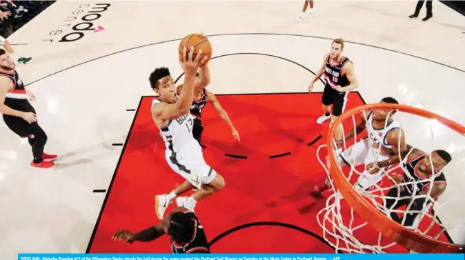  ??  ?? PORTLAND: Malcolm Brogdon #13 of the Milwaukee Bucks shoots the ball during the game against the Portland Trail Blazers on Tuesday at the Moda Center in Portland, Oregon. — AFP