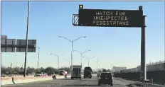  ?? GIOVANNA DELL’ORTO/AP ?? AN ELECTRONIC SIGN FLASHES “Watch for unexpected pedestrian­s,” on Dec. 20, 2022, on the highway next to the fenced Us-mexican border just east of downtown El Paso, Texas, next to one of the three bridges that connect the Texas city with the sprawling metropolis of Juarez, Mexico.