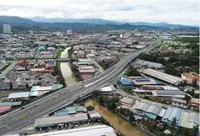  ?? ?? Busy period: A view of Azam Jaya’s flyover project over Jalan Lintasjala­n Tuaran in Kota Kinabalu. The firm has five ongoing projects at the moment with an order book of Rm700mil.