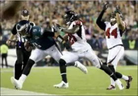  ?? MATT ROURKE — THE ASSOCIATED PRESS ?? Eagles quarterbac­k Nick Foles, left, is forced out of bounds by Atlanta Falcons defensive back Desmond Trufant, center, and linebacker Vic Beasley ... but not before burning the Falcons for 15 yards on ‘Philly Special II,’ in the second-half spark to a stagnant offense in an 18-12 win Thursday.