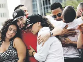  ?? Drew Angerer, Getty Images file ?? “Donald Trump’s renewed call for a temporary halt on Muslim migration to the U.S. is just as deficient as when he first proposed it …” Mourners gather at a makeshift memorial prior to a June 13 vigil for the victims of the Pulse Nightclub shootings in...