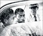  ?? JOHN BOSS — THE ADVOCATE ?? In this February 1964 photo, Henry Montgomery, flanked by two deputies, awaits the verdict in his trial for the murder of Deputy Sheriff Charles H. Hurt in Louisiana.