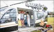  ??  ?? Scarlett Nachampass­ak bumps her head inside a helicopter at the expo. The event included public safety displays, merchant booths and children’s activities.