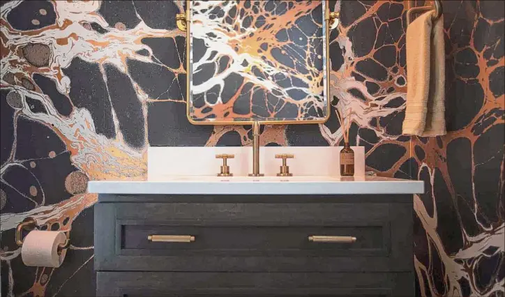  ?? Paul Buckowski / Times Union ?? A Kennedy Taylor-designed bathroom is highlighte­d by a black-and-gold color concept, which feels luxe.