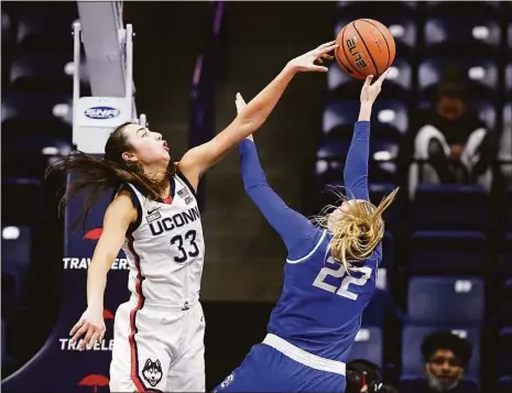  ?? Jessica Hill / Associated Press ?? UConn’s Caroline Ducharme (33) blocks a shot by Creighton’s Carly Bachelor (22) in the second half in January in Storrs.