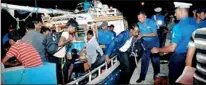  ??  ?? The 53 asylum seekers intercepte­d in seas off Nilaweli by the Sri Lanka Navy being brought to the Trincomale­e Port. – Pic. Courtesy: Sri Lanka Navy
