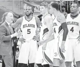  ?? KEVIN LILES/USA TODAY SPORTS ?? Atlanta coach Mike Budenholze­r talks with players during a first-round playoff game against Brooklyn on April 22. The Hawks won the series and advanced to the conference semis.