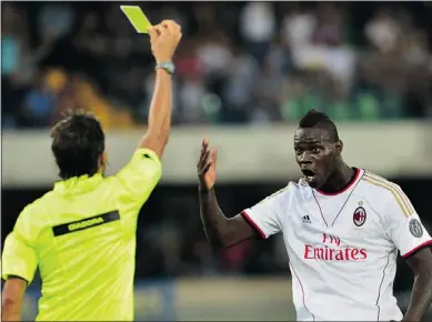 ?? — GETTY IMAGES ?? AC Milan’s Mario Balotelli reacts as referee Gianpaolo Calvarese shows him a yellow card during the Serie A match between Verona and Milan at Bentegodi Stadium on Saturday.